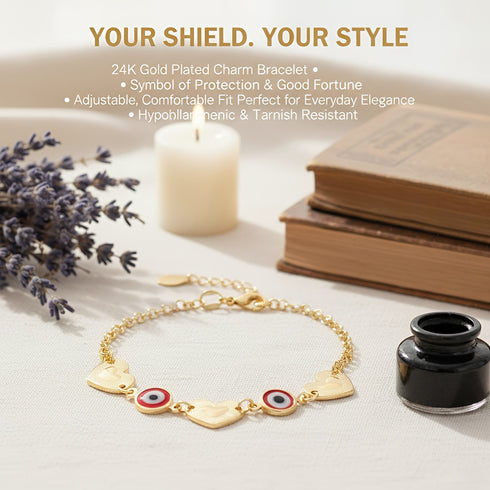 A gold Heart Rolo Link bracelet with heart and circular charms rests among books, lavender, a candle, and an ink bottle.
