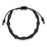 The Genuine Azabache Bracelet, designed as unisex jewelry for both men and women, offers spiritual protection with its geometric black beads and two small red accents. It features an adjustable black rope for easy fastening.