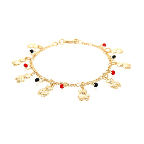 The Teddy Bears Red and Black Lucky Charms Baby Bracelet is a delicate 14k gold-filled piece adorned with small charms, showcasing meticulously arranged red, black, and gold accents along its length, displayed on a white background.