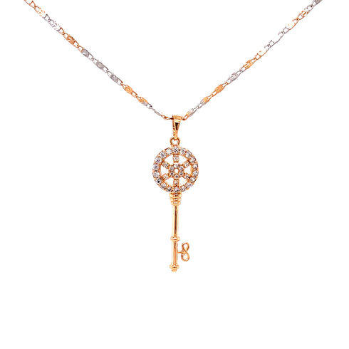 The Beautiful Iced Key Pendant Necklace boasts a luxurious two-tone 14k rose-silver and gold-filled finish, featuring a striking pendant encrusted with sparkling diamonds. Its elegance is further enhanced by the Valentin Mariner chain, while the key's ornate circular design adds an extra touch of sophistication.