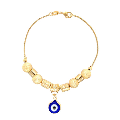 The Blue Evil Eye Charm Bracelet is crafted with 14k gold-filled materials, showcasing textured gold beads and cylindrical accents. It features a striking blue and white evil eye charm that elegantly hangs at the center of a smooth snake chain link.