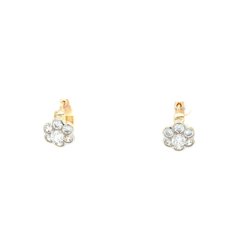 A pair of daisy flower earrings crafted in rose gold, featuring a central zirconia stone surrounded by smaller gems in a delicate huggie design.