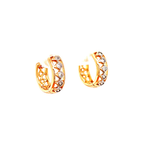 The Tiny Zirconia Stones Huggies Earrings in rose gold, featuring a captivating geometric design and adorned with delicate zirconia stones, are elegantly displayed against a pristine white background.