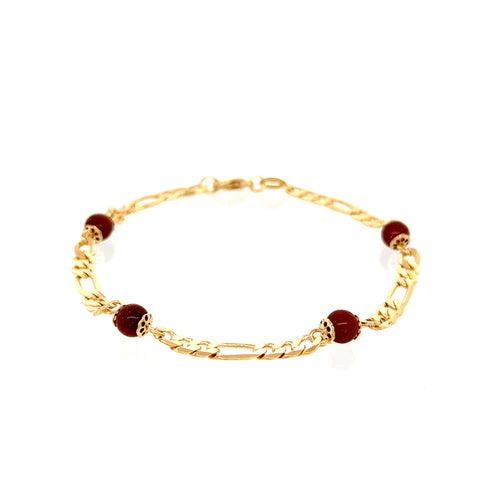 The Aventurine Goldstone in a Figaro Chain Link Bracelet showcases a delicate 14k gold-filled design, adorned with dark red beads and decorative gold accents arranged symmetrically.