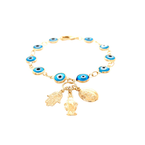 A gold bracelet featuring aqua blue evil eye beads is embellished with three exquisite charms: a Hamsa hand, a Virgin Mary figure, and an oval disk. It is beautifully arranged in a circle against a white background.