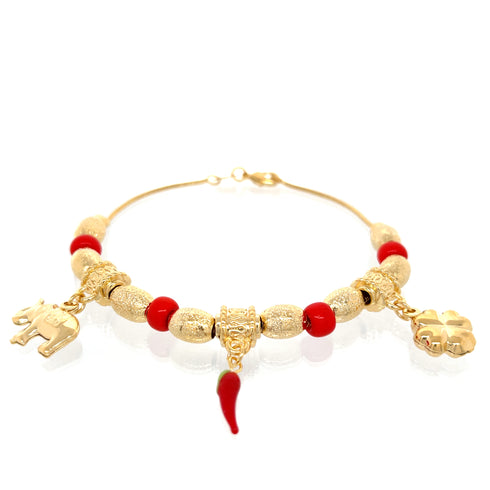 Introducing the "Lovely Elephant, Clover and Chili Lucky Charm Bracelet" crafted in 14k gold-filled material. This exquisite piece features textured beads, vibrant red beads, and three symbolic lucky charms: an elephant, a red chili pepper, and a four-leaf clover. Designed to offer spiritual protection, this elegant bracelet is beautifully showcased against a white background.