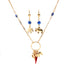 The Mega Lucky Charm Pendant Necklace features a 14K gold-filled Cuban link chain adorned with charms like an elephant and a red horn, accompanied by matching earrings embellished with blue and gold accents and elephant charms. This set exudes elegance while providing a sense of protection and luck, all beautifully displayed against a white background.