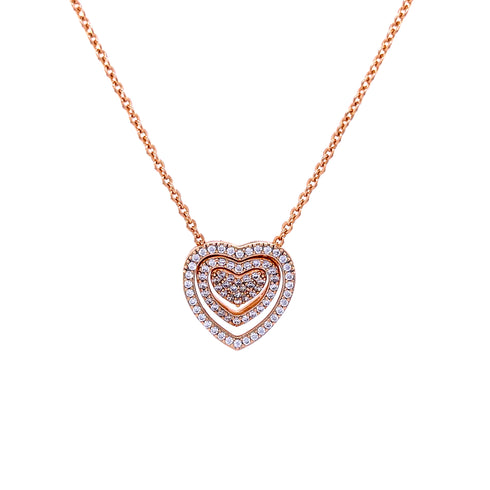 The Infinite Love Heart Pendant Zirconia Stones Rose Gold filled Necklace showcases a captivating heart-shaped design crafted from 14K rose gold-filled metal, featuring three concentric hearts embellished with sparkling zirconia stones and suspended gracefully on a delicate chain against a pristine white background.