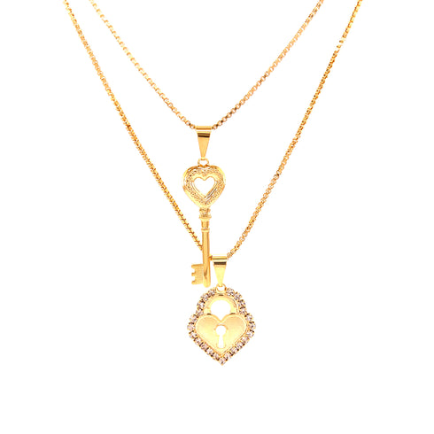 The Heart Lock and Key Zirconia Stones Pendant Stacked Necklace showcases a 14k gold-filled chain with two exquisite pendants: a decorative key and a heart lock adorned with zirconia stones. The elegant chain beautifully complements the intricate designs of this charming necklace.