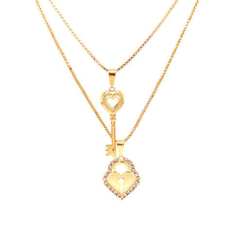 The Heart Lock and Key Zirconia Stones Pendant Stacked Necklace showcases a 14k gold-filled design featuring two elegant pendants: a rhinestone-studded heart-shaped lock and a meticulously crafted key with a heart-shaped top, both gracefully suspended on fine chains.