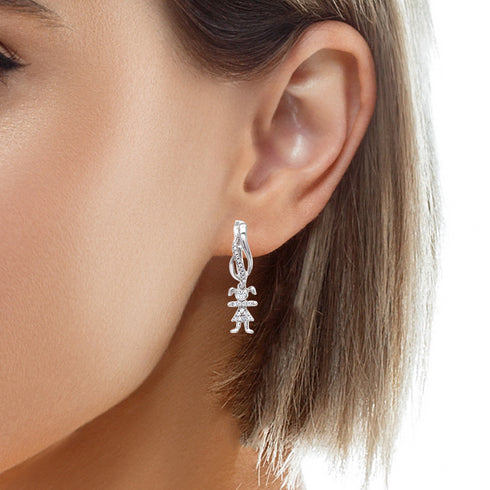 A close-up captures a person wearing the Cute Little Girl Drop Earrings, crafted with white gold and glimmering zirconia stones. The earrings elegantly contrast with the person's short, straight hair and clear complexion.